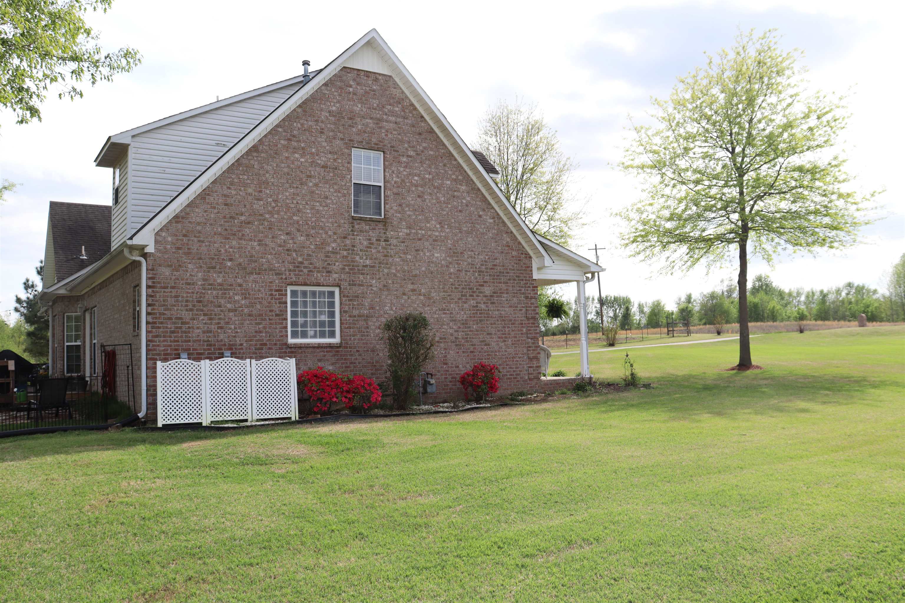 730 Durhamville Road Ripley, TN 38063 - Photo 35 of 40 a backyard of house with swing and slide