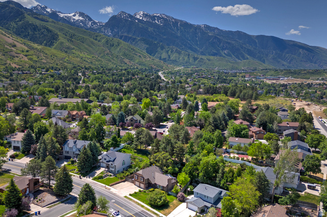 3310 Creek Road Salt Lake City, UT 84121 - Photo 48 of 49 Aerial perspective showcasing a residential area with mature trees, established properties, and distant snow-capped mountains
