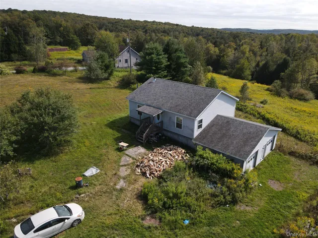a view of a house with a yard and lake view