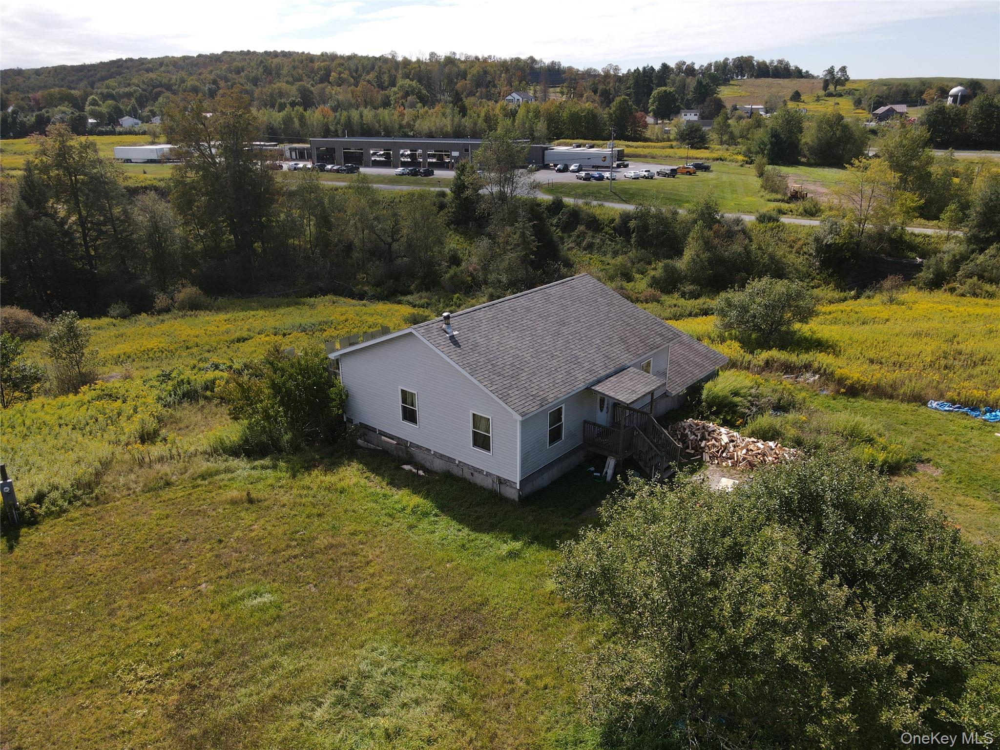 9 Queen Mountain Road, Unit 64 Ferndale, NY 12734 - Photo 18 of 20 a view of a house with a yard and lake view