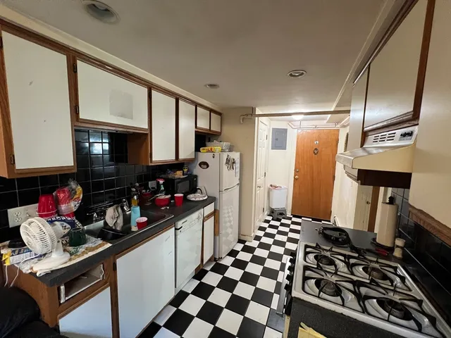 a kitchen with a sink stove and refrigerator