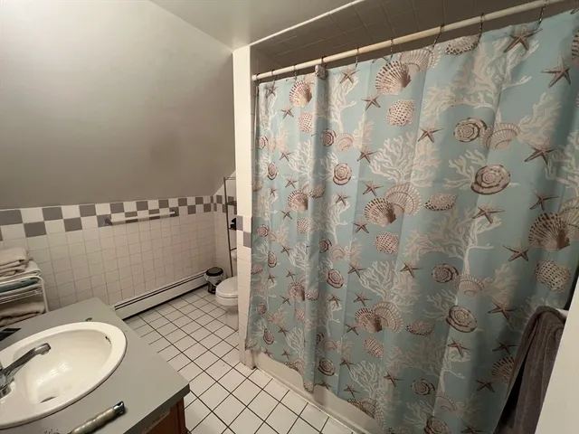 a bathroom with a sink a mirror and a toilet