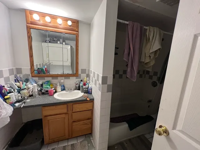 a bathroom with a sink a toilet and a mirror