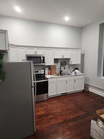a kitchen with a sink and refrigerator