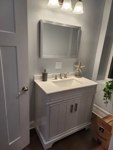 a bathroom with a sink and a mirror
