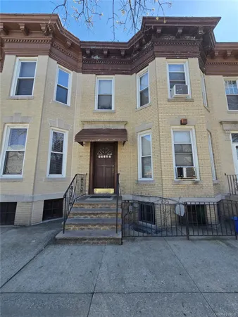 a view of a brick building with many windows