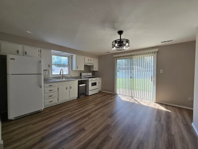 a kitchen with stainless steel appliances a refrigerator sink and cabinets