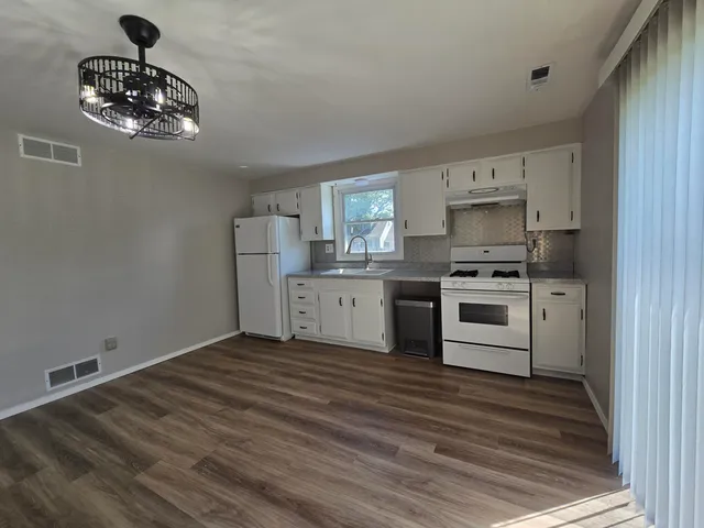 a kitchen with a stove cabinets and window