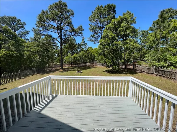 a view of deck and deck with large trees