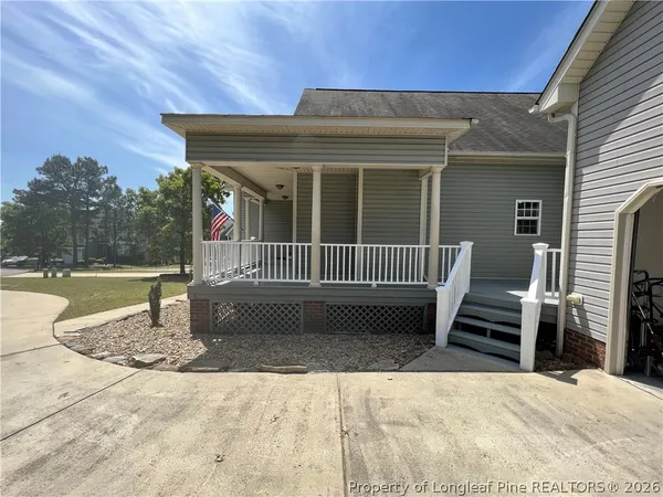 a view of a house with a wooden fence