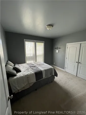 a bedroom with a bed and window