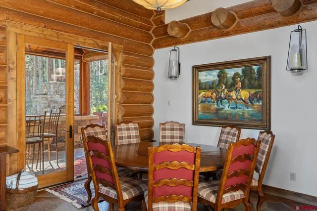 a dining room with furniture and wooden floor