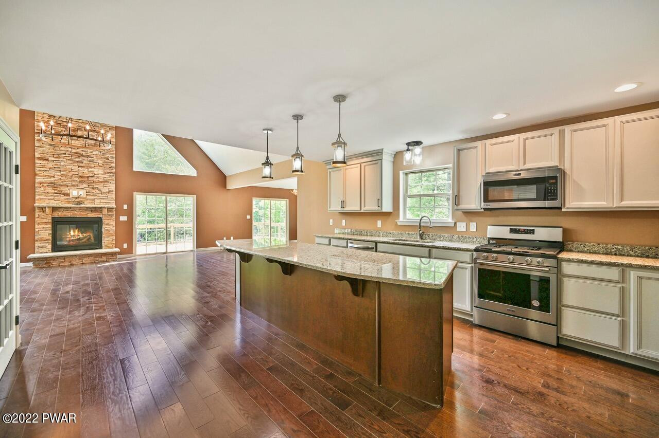45 Rockway Road Lake Ariel, PA 18436 - Photo 26 of 65 a large kitchen with stainless steel appliances granite countertop a stove and a wooden floors