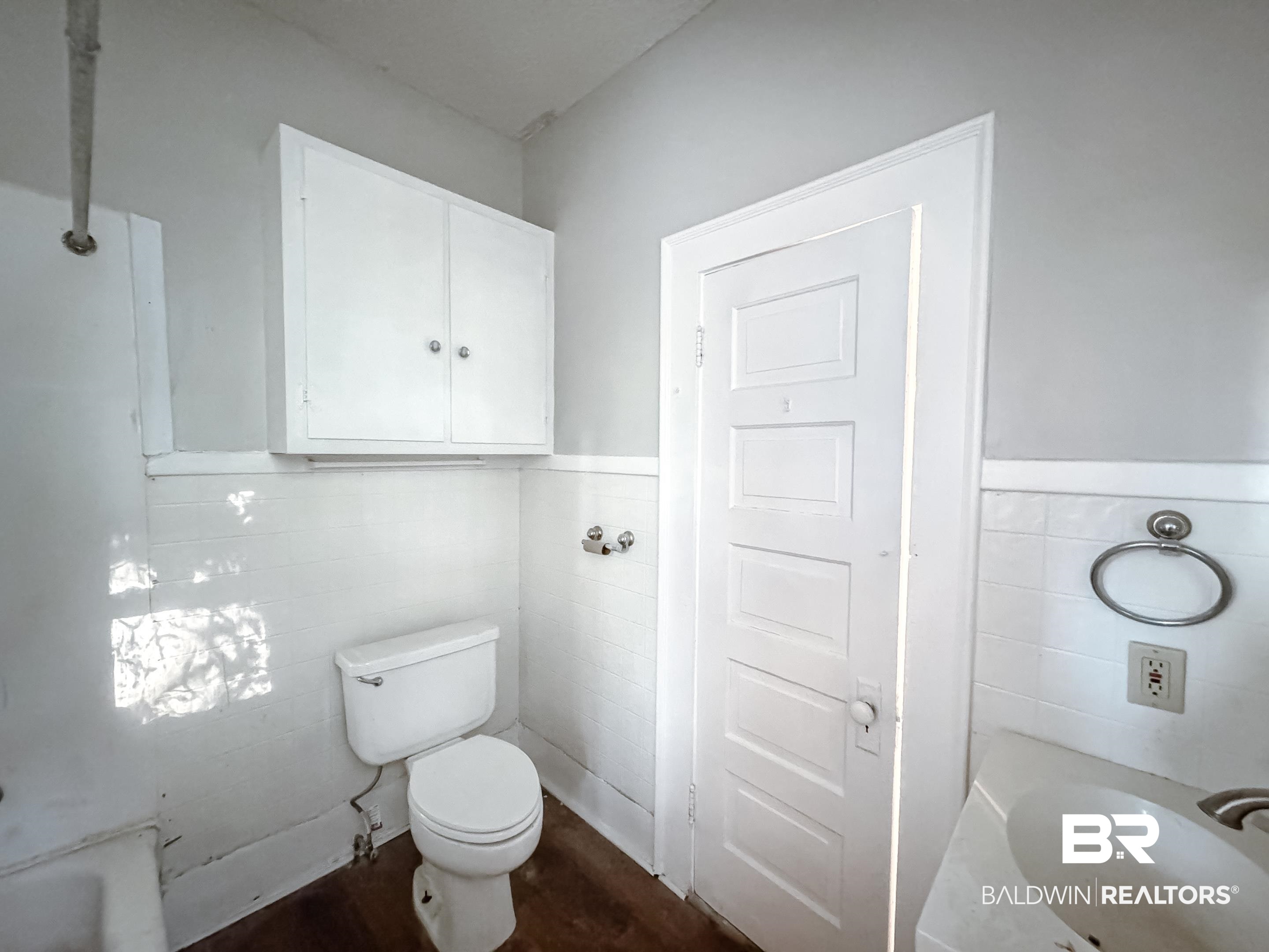 206 1st Street Mobile, AL 36611 - Photo 16 of 26 Full bathroom featuring wainscoting, tile walls, dark wood-style floors, and vanity