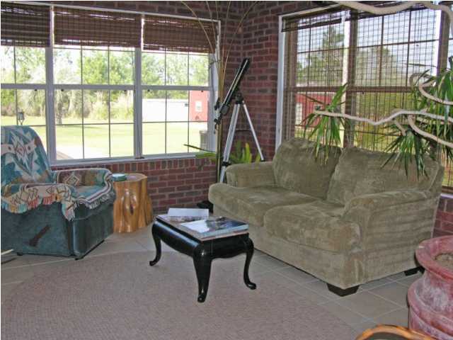 5865 Bush Road Baker, FL 32531 - Photo 11 of 32 a living room with furniture and a floor to ceiling window