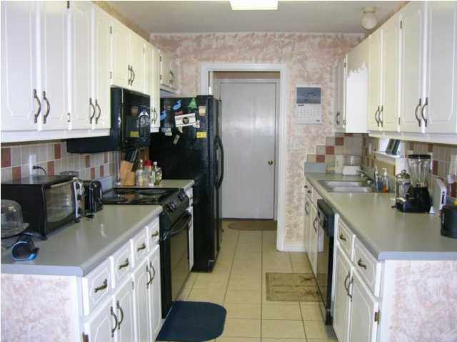 5865 Bush Road Baker, FL 32531 - Photo 12 of 32 a kitchen with a sink stove and refrigerator