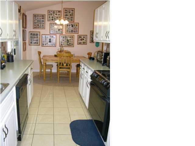 5865 Bush Road Baker, FL 32531 - Photo 13 of 32 a kitchen with a sink and cabinets