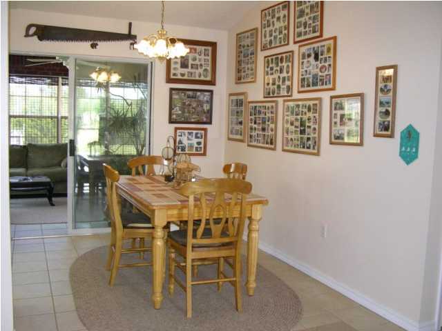 5865 Bush Road Baker, FL 32531 - Photo 9 of 32 a dining room with furniture a chandelier and window