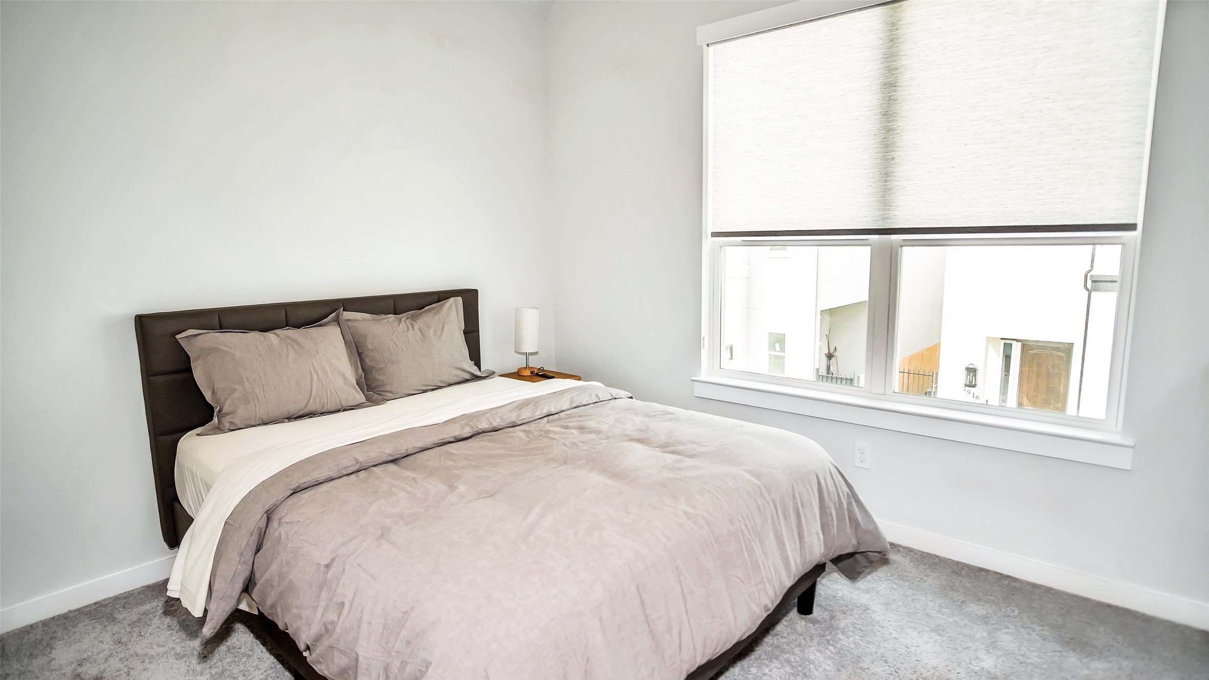 1919 Pueblo Nuevo Path Houston, TX 77077 - Photo 18 of 50 a large bed sitting in a bedroom next to a window