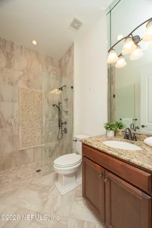 an aerial view of a house with a garden and lake view