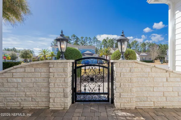 a view of a house with a garden and flowers