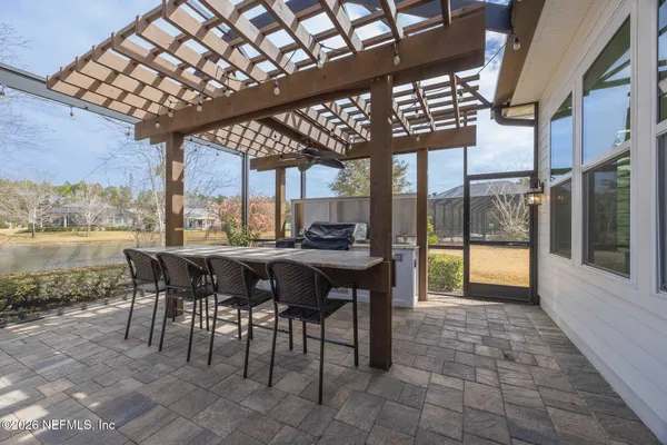 a view of a dining room with furniture and a chandelier
