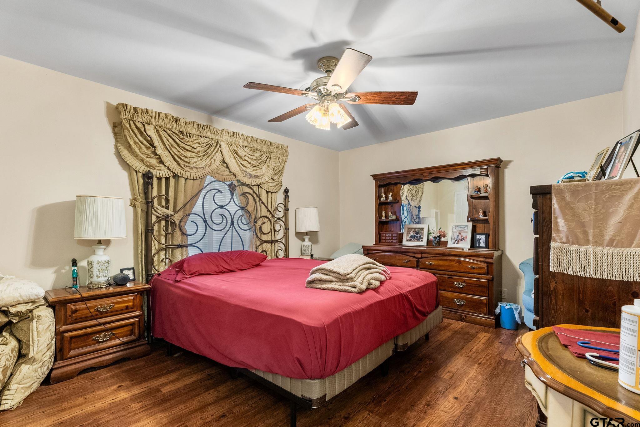203 Pecan Street Rusk, TX 75785 - Photo 11 of 35 a bedroom with a bed and a chandelier