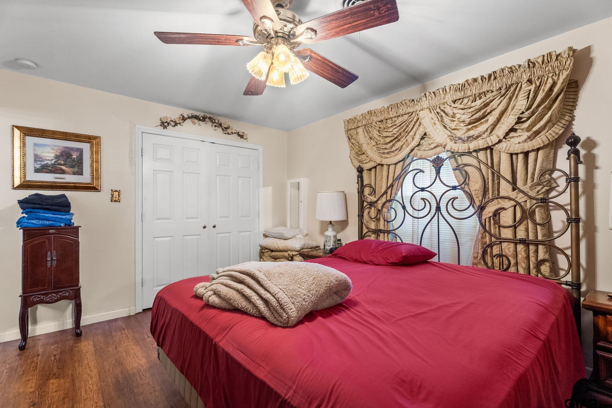 203 Pecan Street Rusk, TX 75785 - Photo 13 of 35 a bedroom with a bed and a chandelier