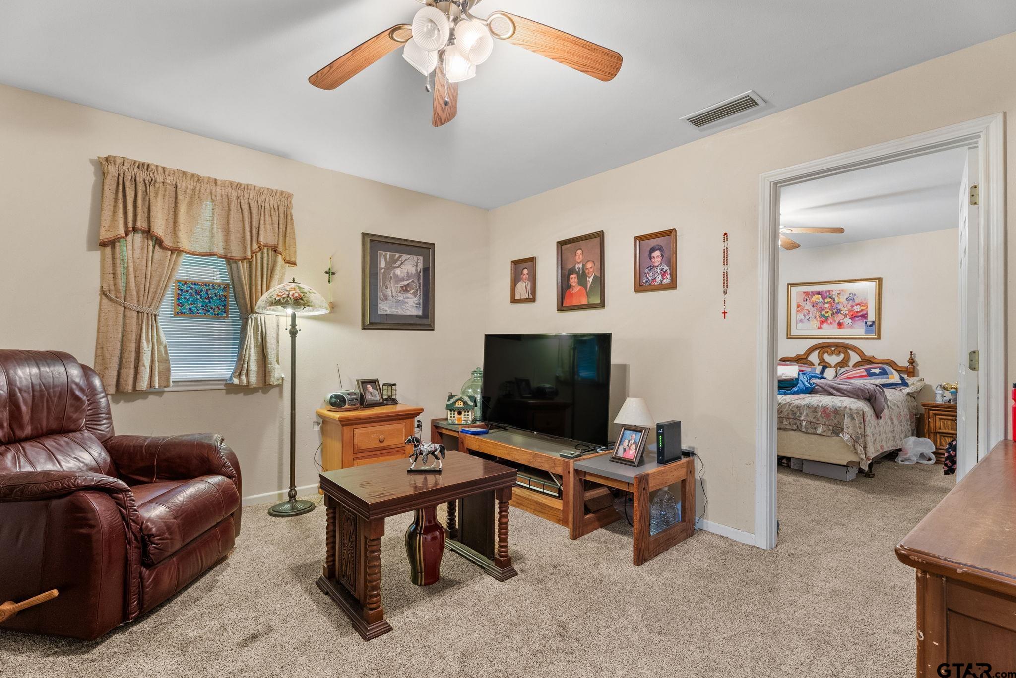 203 Pecan Street Rusk, TX 75785 - Photo 19 of 35 a living room with furniture and a flat screen tv