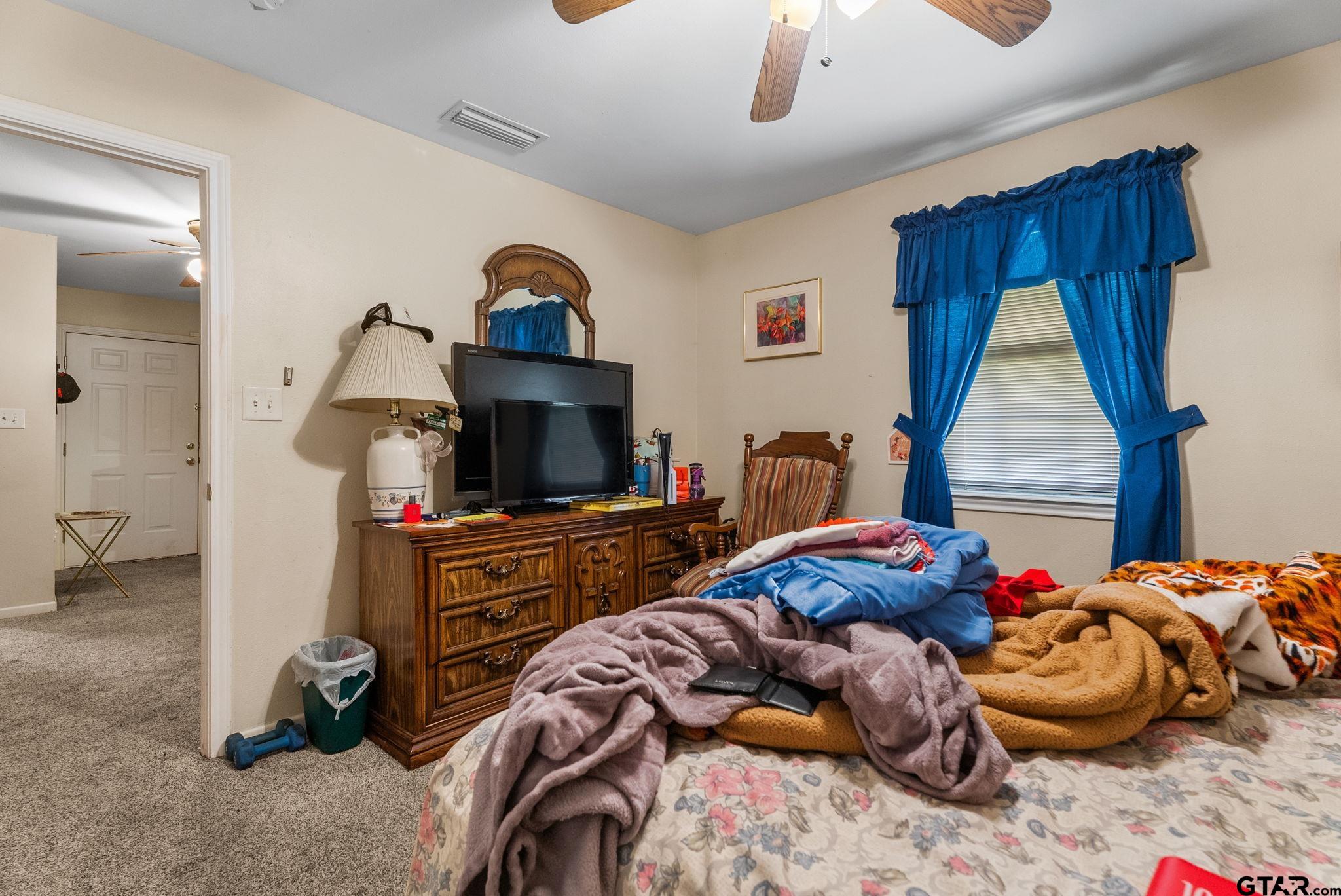 203 Pecan Street Rusk, TX 75785 - Photo 23 of 35 a bedroom with bed and a chandelier