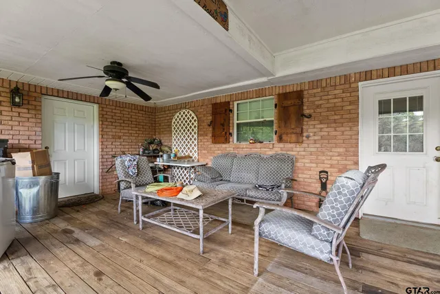 a view of a house with backyard and sitting area