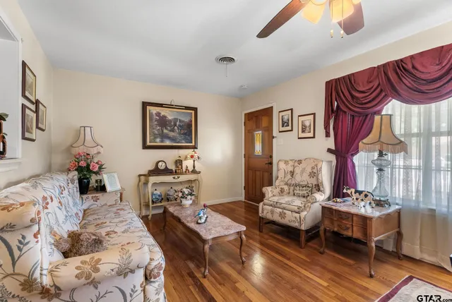 a bedroom with furniture and a wooden floor