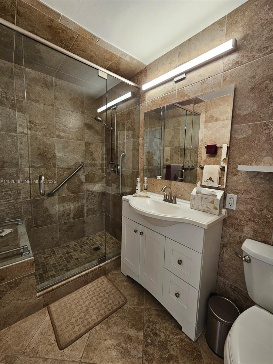 44 Cocoanut Row, Unit 306A Palm Beach, FL 33480 - Photo 3 of 11 a bathroom with a sink mirror toilet and shower
