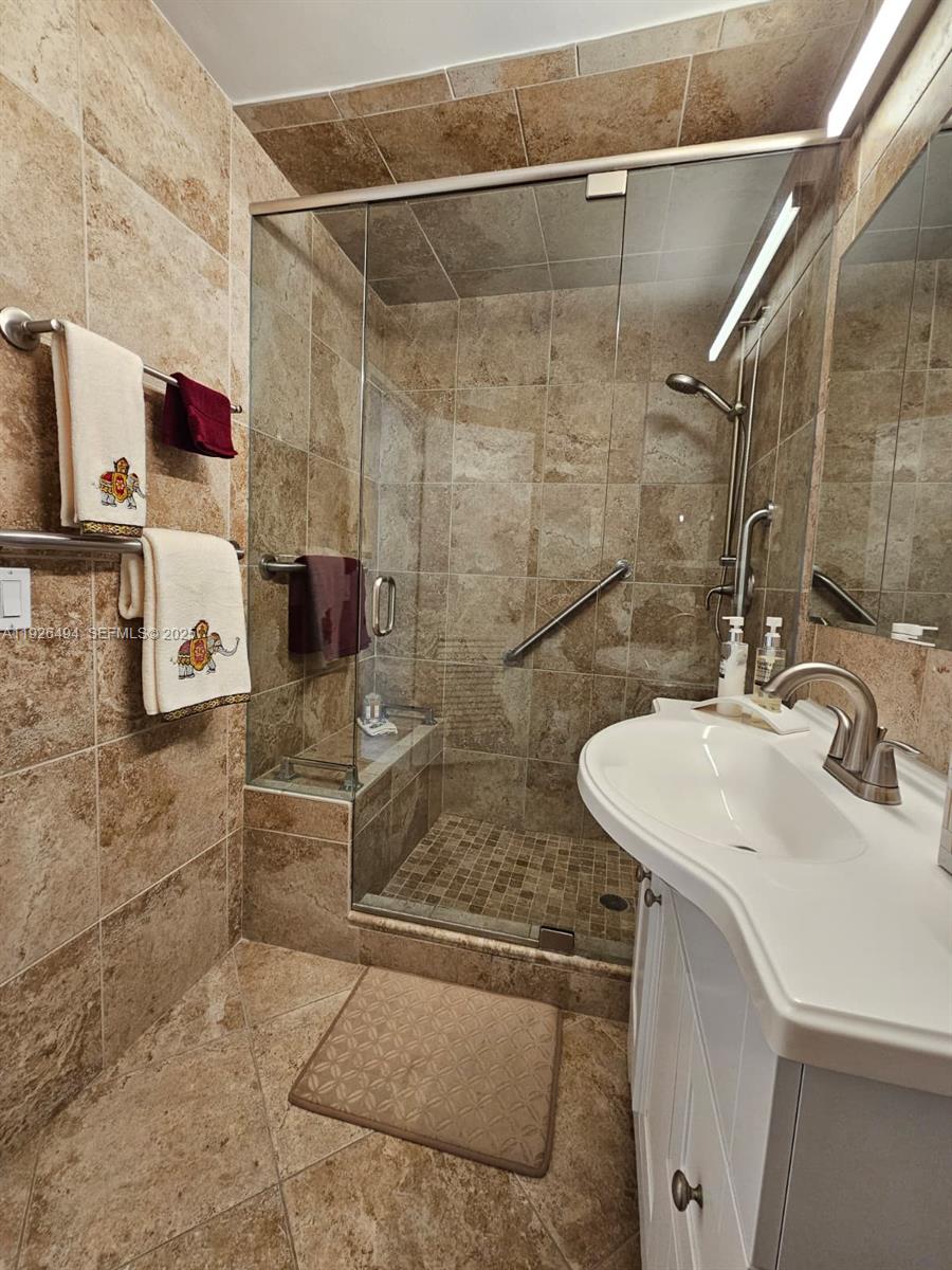 44 Cocoanut Row, Unit 306A Palm Beach, FL 33480 - Photo 4 of 11 a bathroom with a sink and a mirror