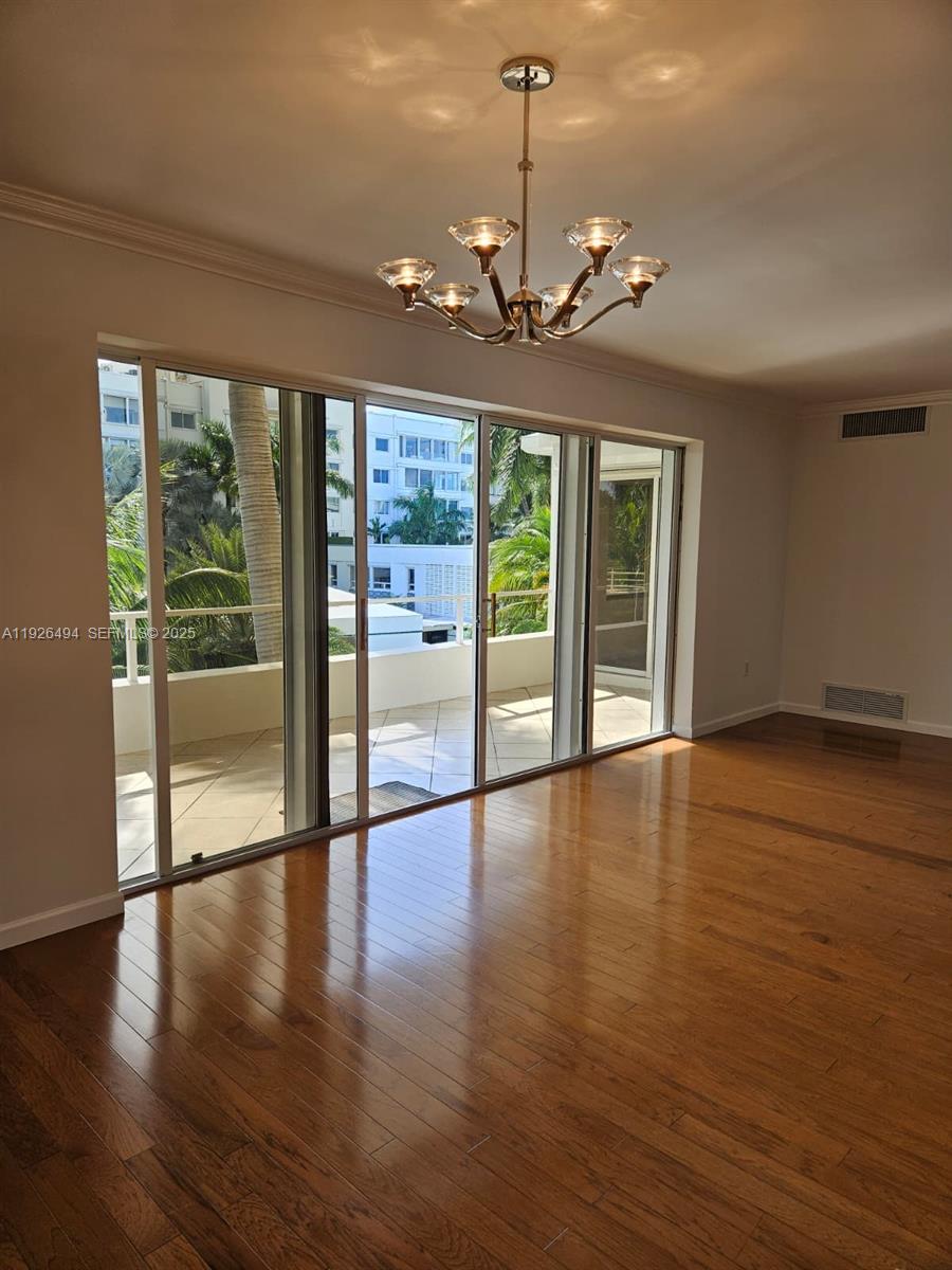 44 Cocoanut Row, Unit 306A Palm Beach, FL 33480 - Photo 9 of 11 a view of an empty room with wooden floor and a window