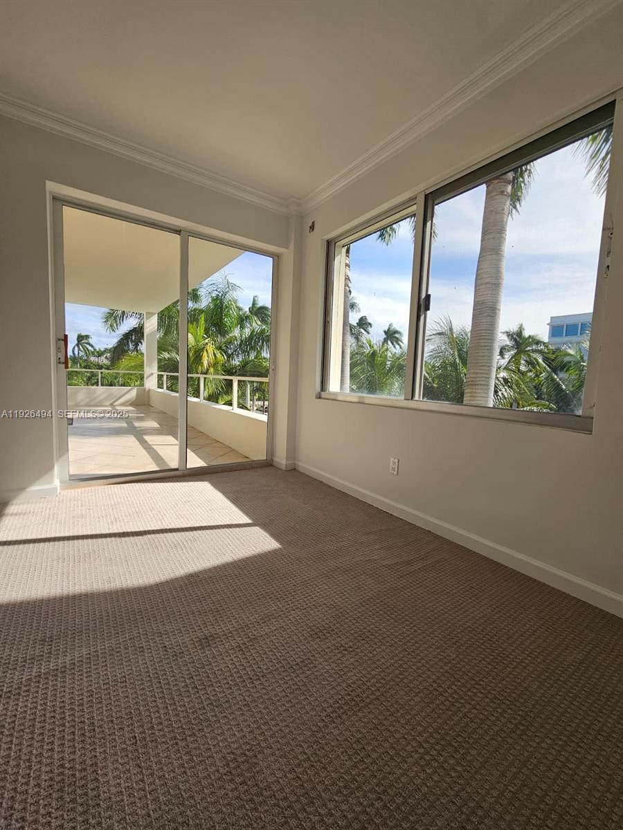 44 Cocoanut Row, Unit 306A Palm Beach, FL 33480 - Photo 10 of 11 a view of an empty room with wooden floor and a window