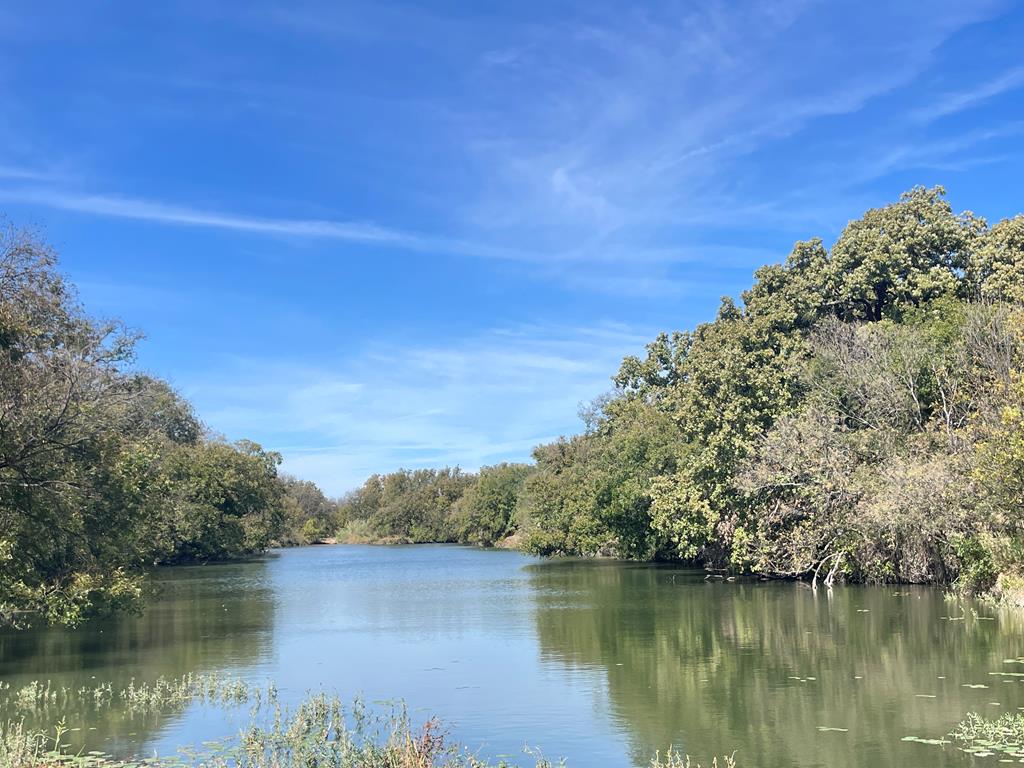 a view of a lake with houses in the back
