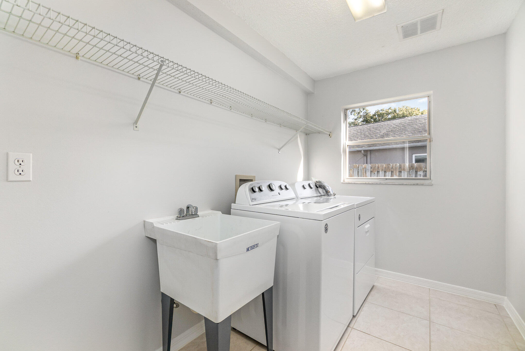 4655 Willow Bend Drive Melbourne, FL 32935 - Photo 21 of 27 a bathroom with a sink a mirror and a window