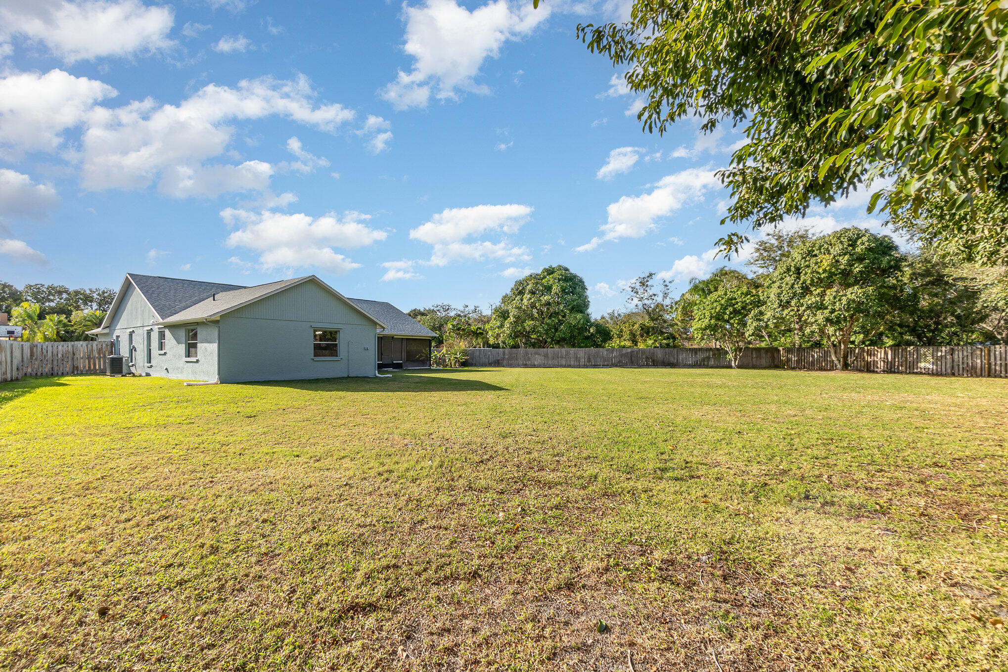 4655 Willow Bend Drive Melbourne, FL 32935 - Photo 25 of 27 a house view with swimming pool and trees in the background