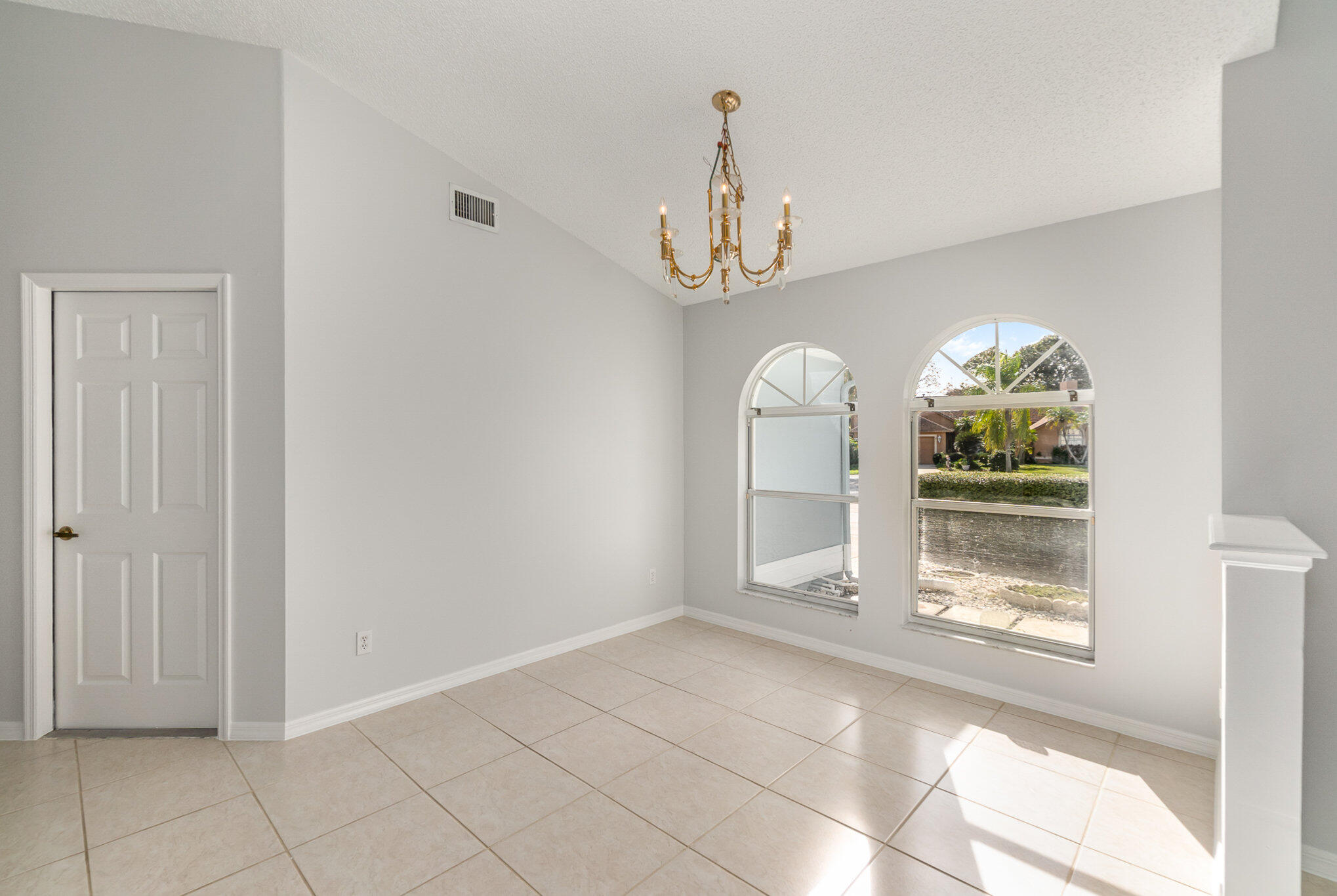 4655 Willow Bend Drive Melbourne, FL 32935 - Photo 7 of 27 a view of a livingroom with wooden floor windows and a chandelier