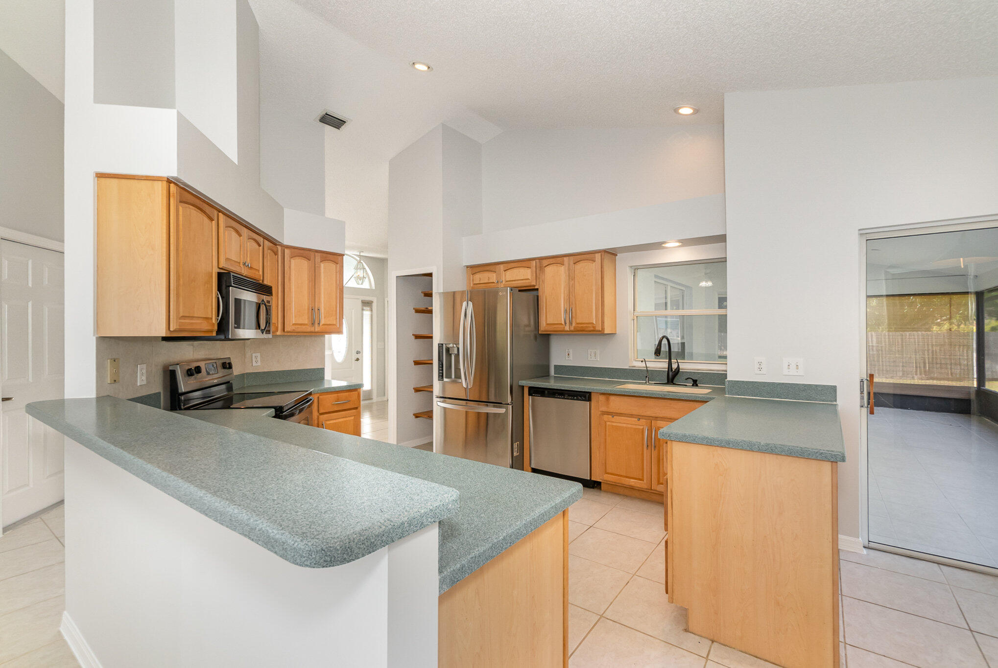 4655 Willow Bend Drive Melbourne, FL 32935 - Photo 8 of 27 a kitchen with stainless steel appliances granite countertop a sink stove and refrigerator