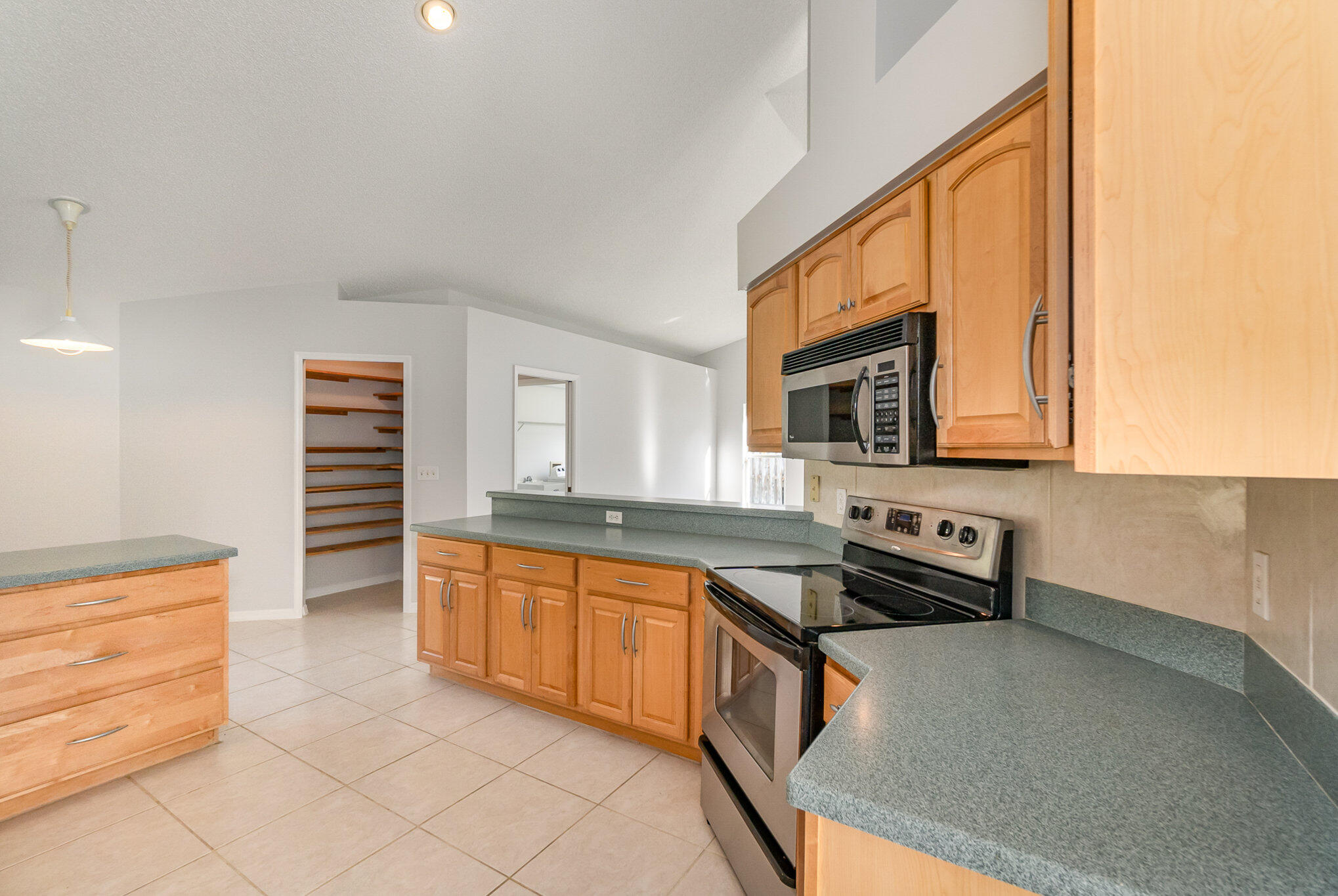 4655 Willow Bend Drive Melbourne, FL 32935 - Photo 9 of 27 a kitchen with stainless steel appliances a sink stove and cabinets