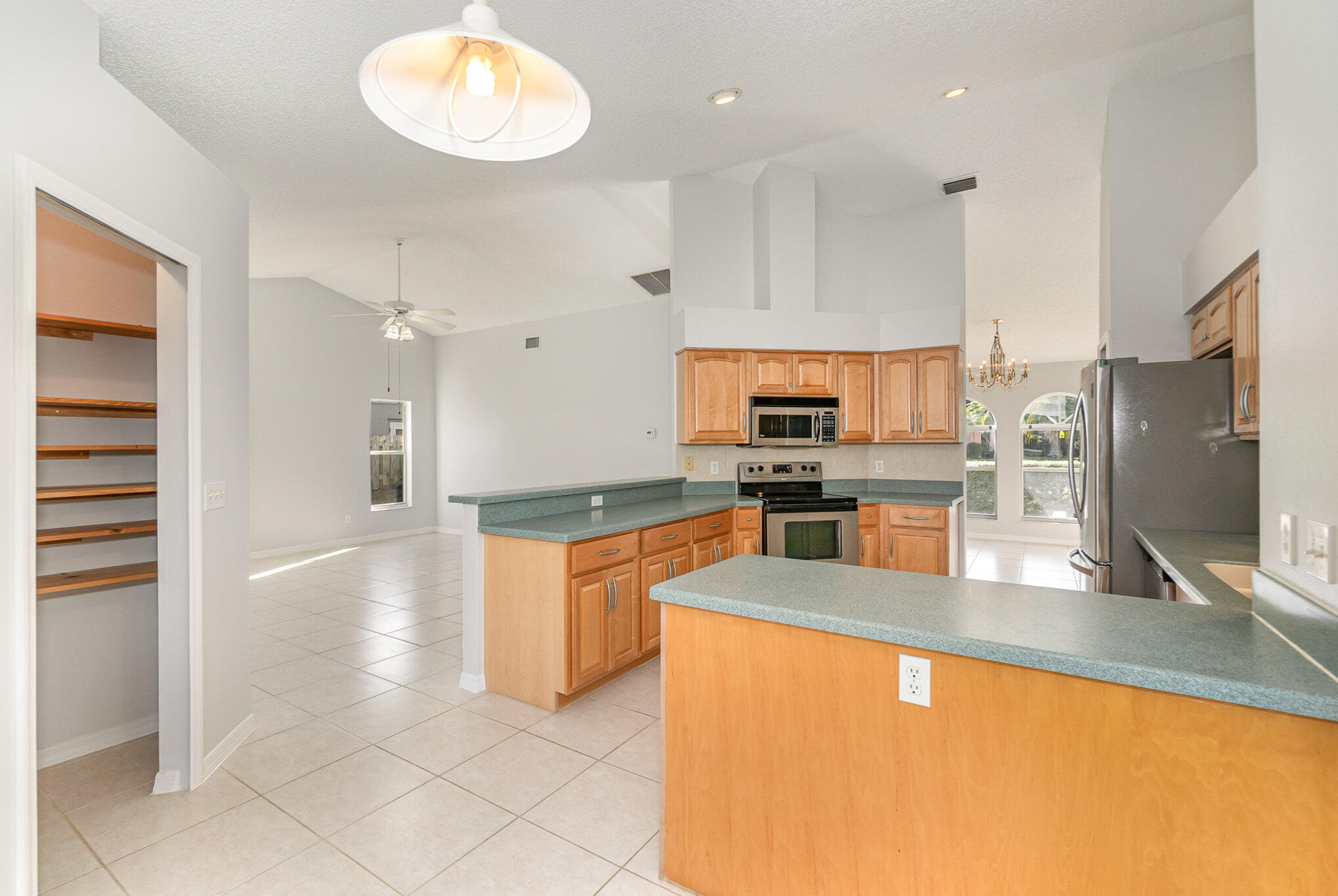 4655 Willow Bend Drive Melbourne, FL 32935 - Photo 10 of 27 a large kitchen with stainless steel appliances lots of counter top space and cabinets