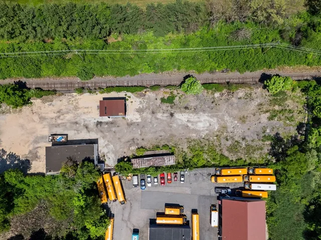 an aerial view of a houses with a yard
