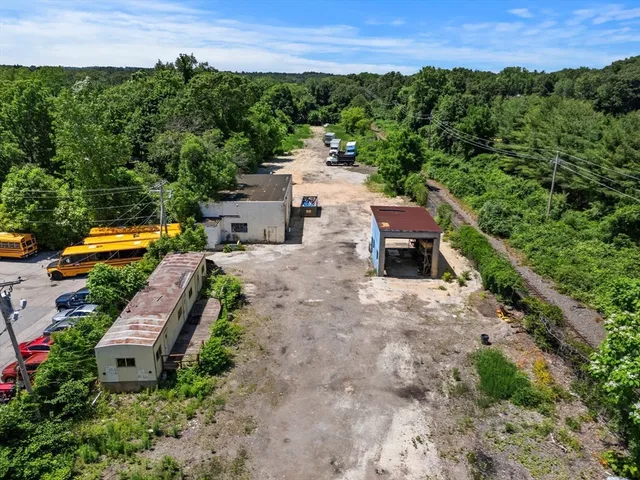 an aerial view of a house with a garden and a yard