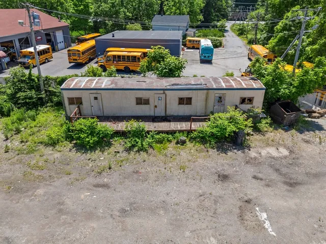 an aerial view of a house with garden space and street view