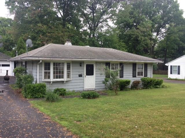 a front view of a house with a yard and porch