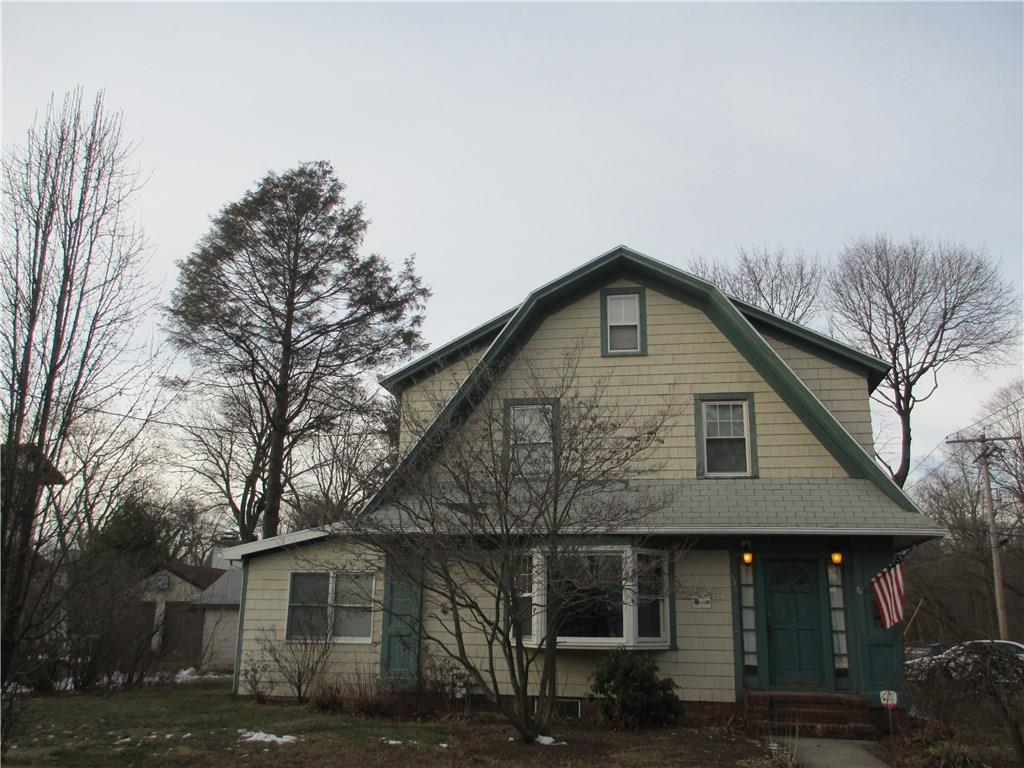 Front with flowering tree and bushes in spring