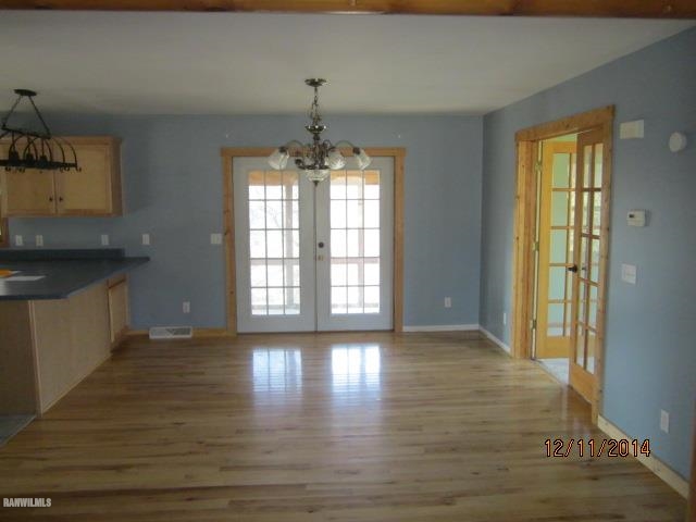 6 Snipe Hollow Road Elizabeth, IL 61028 - Photo 5 of 23 a view of an empty room with wooden floor and a window