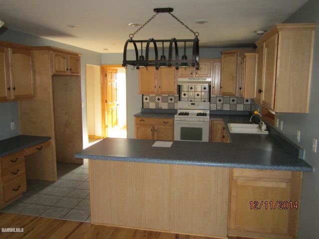 6 Snipe Hollow Road Elizabeth, IL 61028 - Photo 8 of 23 a kitchen with stainless steel appliances granite countertop a sink a stove and a refrigerator